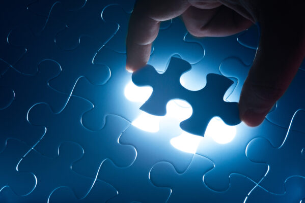 photo of someone placing a blue glowing puzzle piece for an article on the frankenstein effect